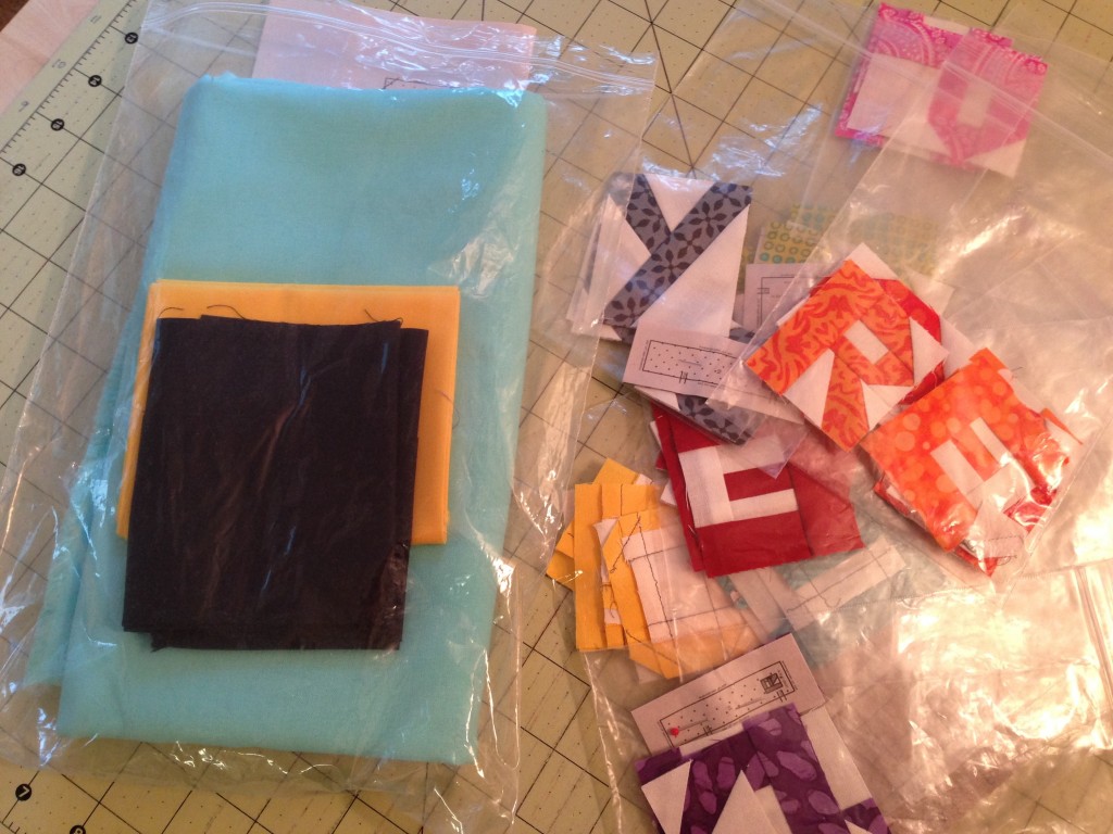 Studio Hack: Small letter quilt blocks and three cuts of fabric are organized in zippered plastic bags