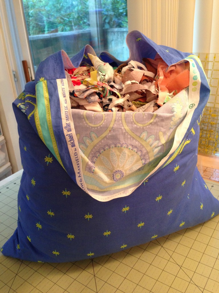 Pillowcase filled with small scraps of fabric. Will be sewn up and donated. 