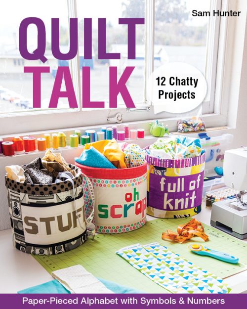 Cover image of the Quilt Talk book features three buckets with the patchwork words of "Stuff," "Oh Scrap" and "Full of Knit" next to a sewing machine.