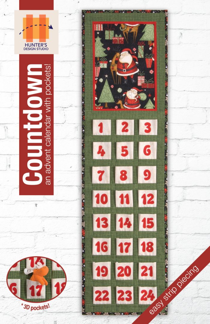 Image is of a Christmas Countdown wall hanging advent calendar with green background fabric, Santa print feature, and 24 white pockets with red lettering.