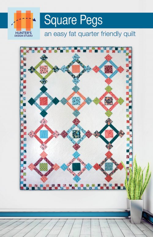 Square Pegs is a quilt pattern that uses coordinating fat quarters to create a square in a square based block that is then placed on point in the final layout.