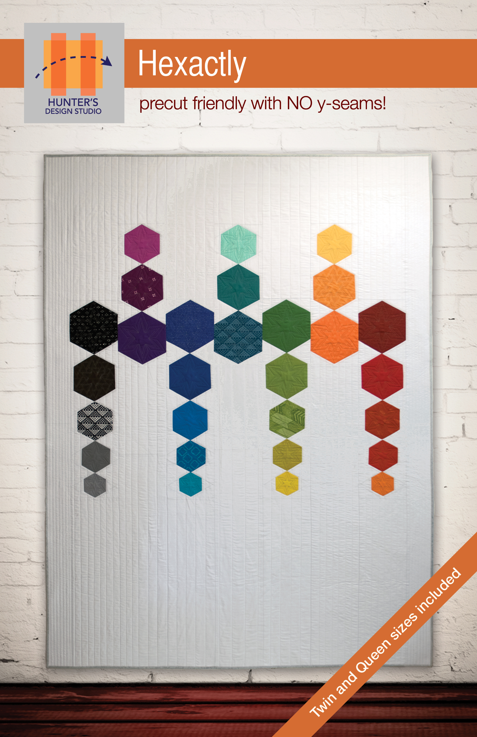 Hexactly is a modern quilt featuring multisized hexagons in five sizes. These hexagons are arrange in lines.