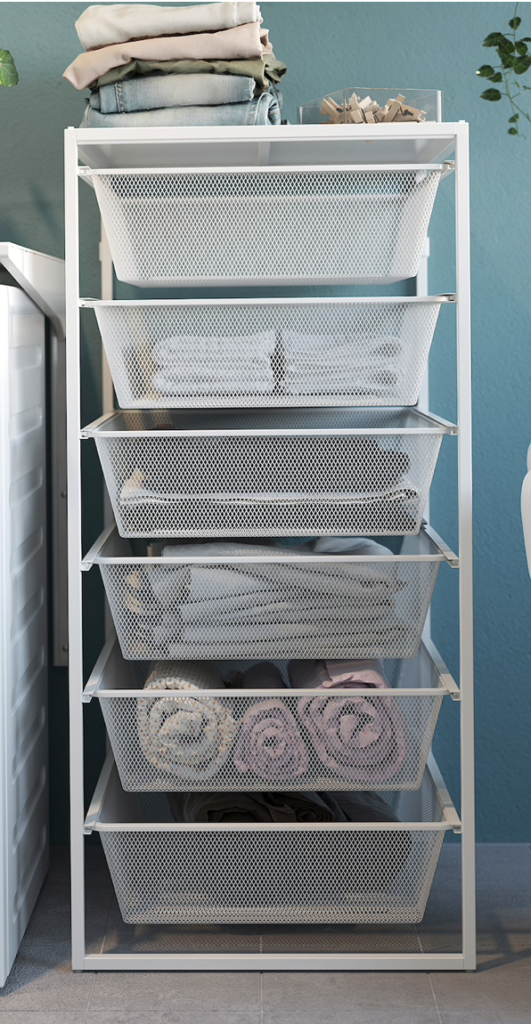 Set of white wire Ikea vertical drawers filled with pale colored linens.  