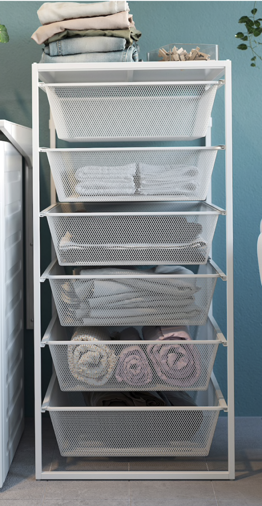 Set of white wire Ikea vertical drawers filled with pale colored linens. 