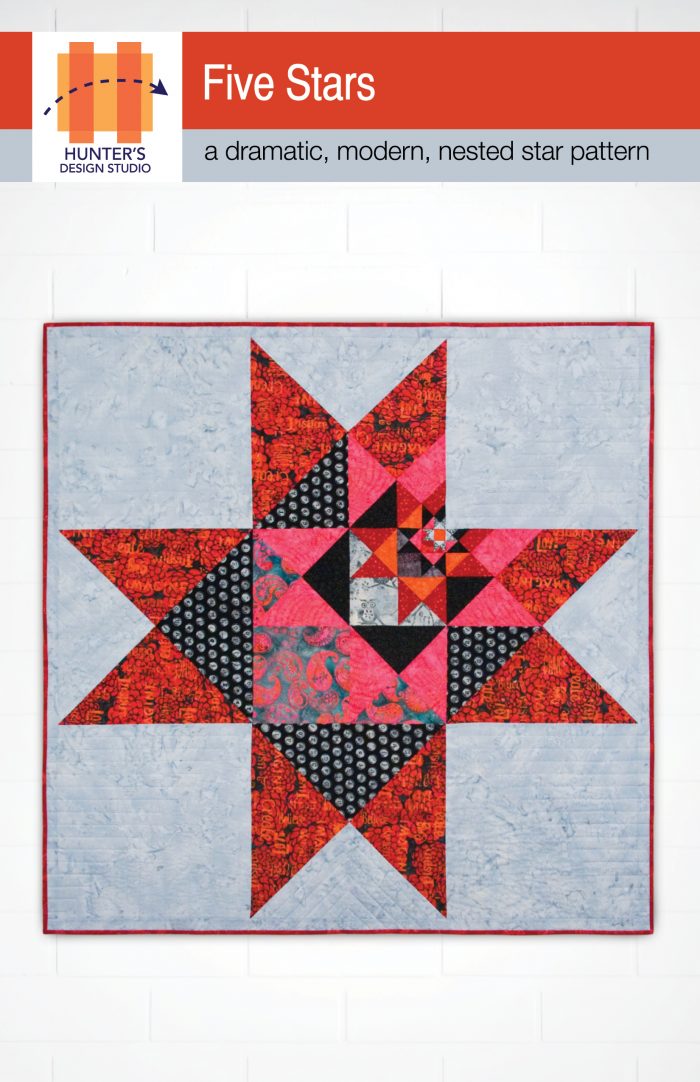 Five stars is a quilt that features nested, off-center stars in the colors of red, black orange and pink.