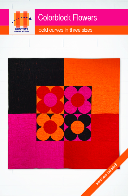 Colorblock flowers is a mid-century modern inspired quilt featuring four color blocked flowers made with curved piecing