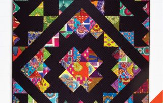 Hitchhikers Star quilt pattern features multicolored African prints with a black background.
