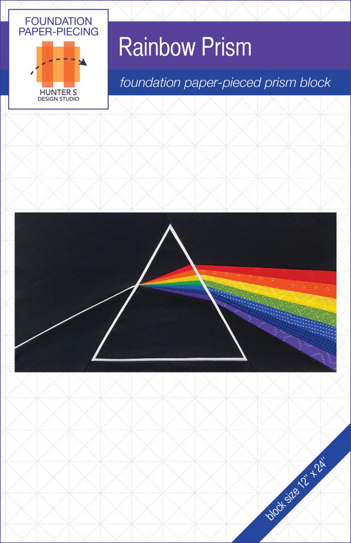 Image is of the cover of the Prism block pattern. The quilt block pictured is of a black background with a white triangle in the center. A beam of light is coming from the left through the triangle and splitting into red, orange, yellow, green, blue, indigo and purple.