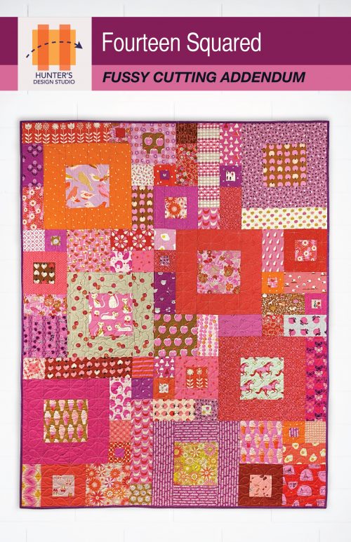 Image is of the cover of the Fourteen Squared Fussy Cutting addendum. Quilt pictured is in pinks, oranges and purples featuring fussy cut fabric.