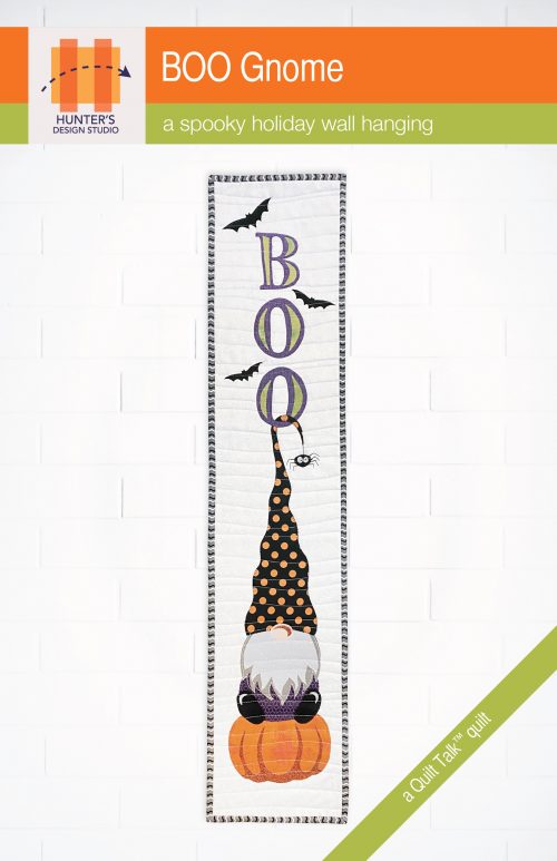 Image is of the pattern cover of Boo Gnome, a vertical wall hanging featuring the word 'boo' written vertically, with a gnome and his hat hooked on to the bottom O. The gnome is sitting on an orange pumpkin.